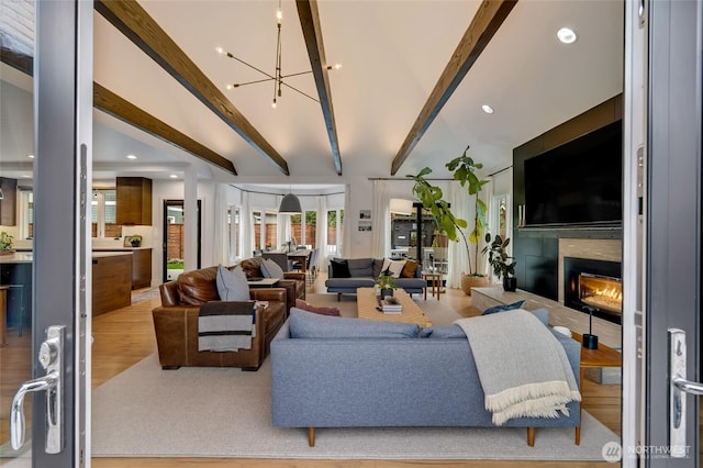 909 11th St, Mukilteo, WA 98275 - living room with lofted ceiling with beams, an inviting chandelier, recessed lighting, wood finished floors, and a tiled fireplace