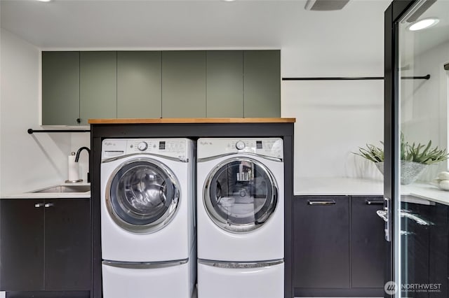 909 11th St, Mukilteo, WA 98275 - washroom featuring washer and dryer, cabinet space, and a sink