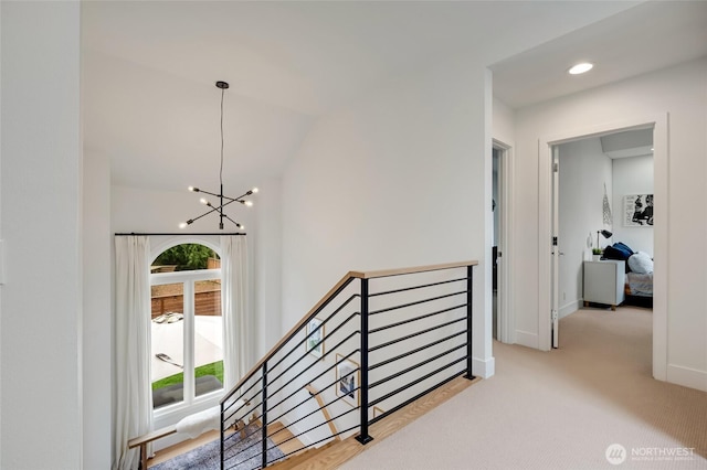 909 11th St, Mukilteo, WA 98275 - hall with carpet flooring, an upstairs landing, a notable chandelier, vaulted ceiling, and baseboards
