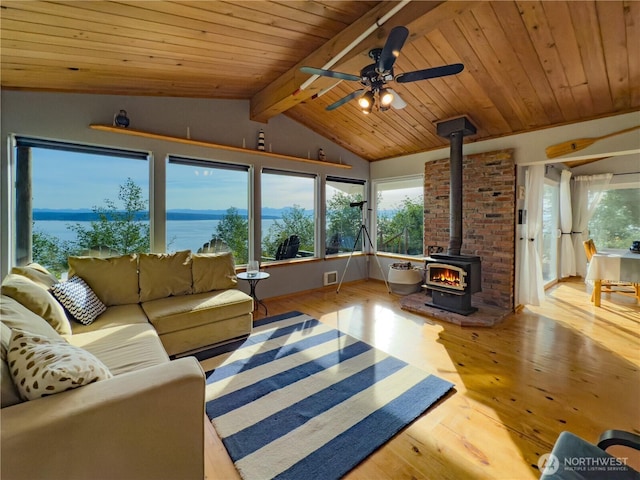 36 K Beach Way, Hat Island, WA 98206 - living area with a wood stove, wooden ceiling, wood finished floors, a water view, and ceiling fan