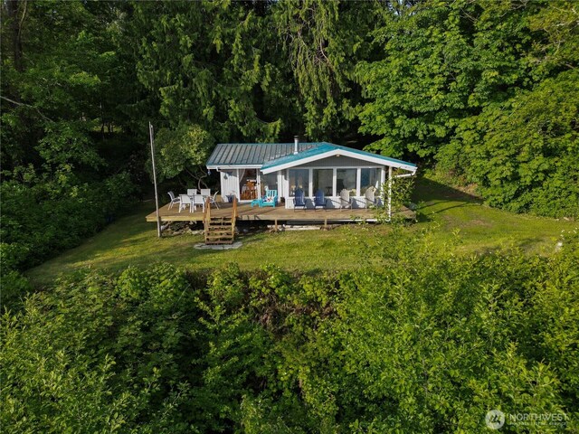 36 K Beach Way, Hat Island, WA 98206 - back of house featuring a wooden deck, metal roof, a yard, and a view of trees