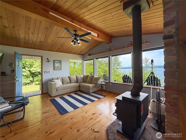 36 K Beach Way, Hat Island, WA 98206 - living area with a wood stove, a ceiling fan, plenty of natural light, hardwood / wood-style flooring, and wooden ceiling