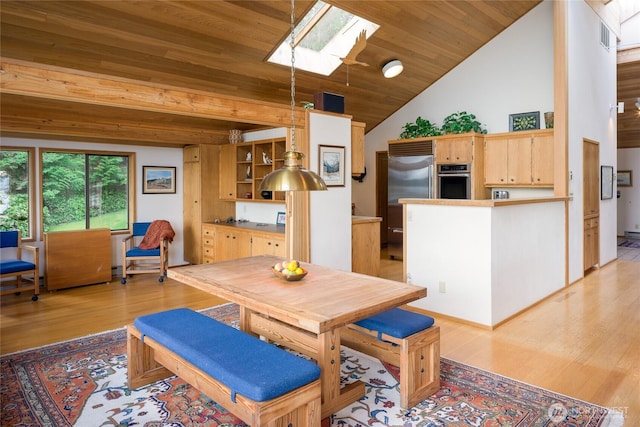 dining space with wooden ceiling, light wood-type flooring, and vaulted ceiling with skylight