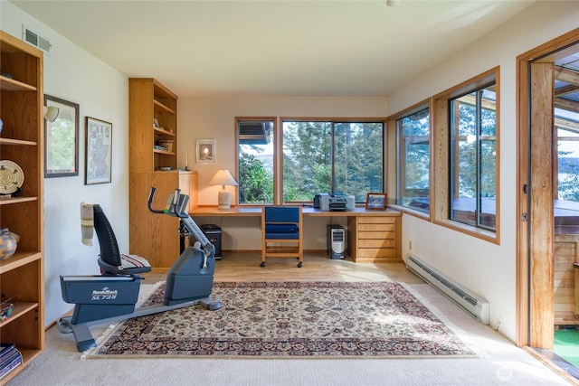 office space featuring visible vents, plenty of natural light, built in desk, and a baseboard radiator