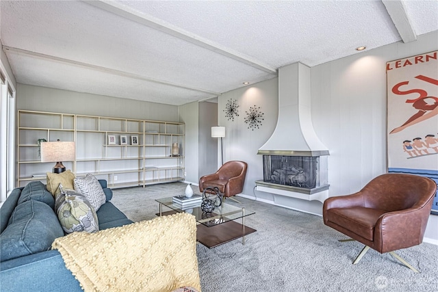 carpeted living area featuring a textured ceiling, wood walls, and beamed ceiling