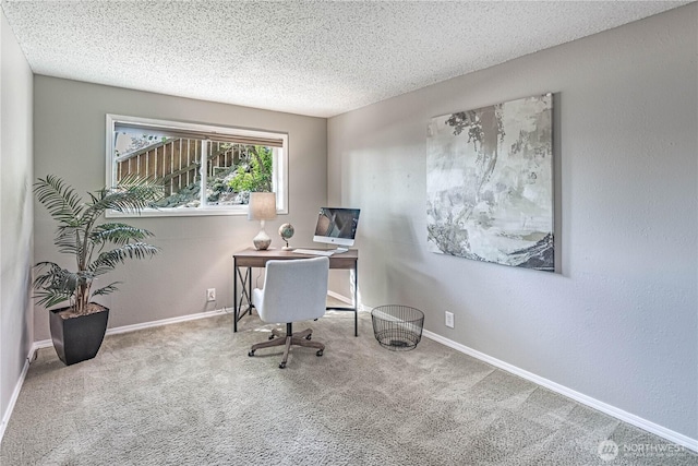 office area featuring carpet floors, a textured ceiling, and baseboards