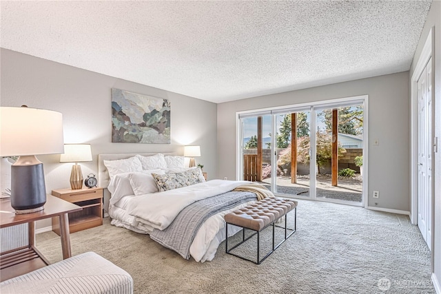 bedroom with carpet flooring, access to outside, a textured ceiling, and baseboards