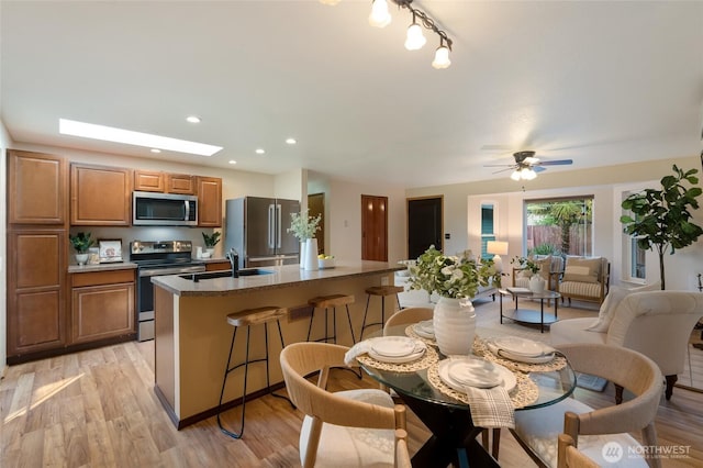dining room featuring light wood-style floors, recessed lighting, and a ceiling fan