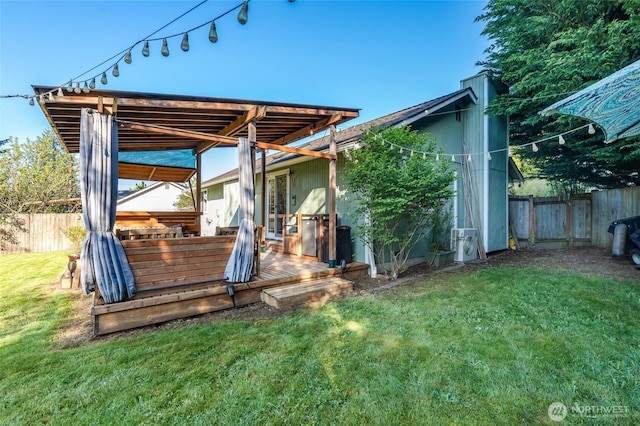exterior space with a lawn, a deck, and a fenced backyard