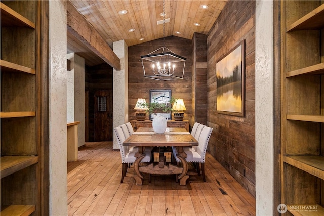 dining area featuring hardwood / wood-style floors, wooden ceiling, vaulted ceiling, and a chandelier
