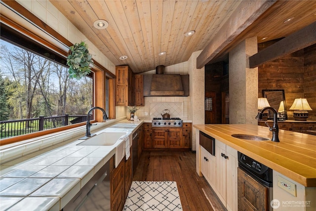 kitchen featuring dishwasher, a sink, tile counters, and stainless steel gas stovetop