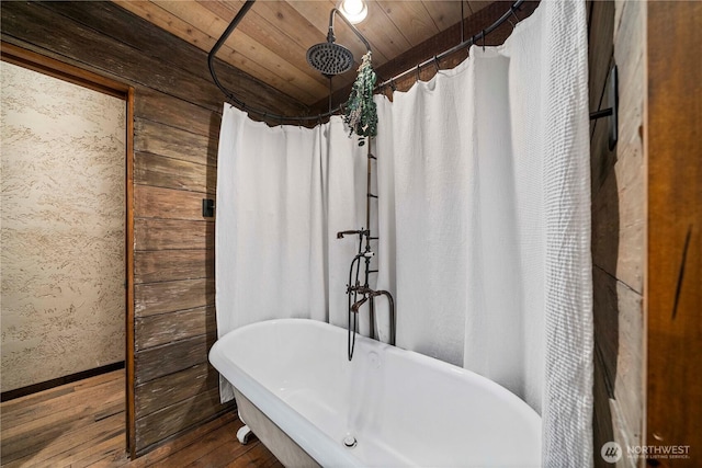 bathroom featuring wood ceiling, hardwood / wood-style flooring, a shower with shower curtain, baseboards, and a freestanding bath