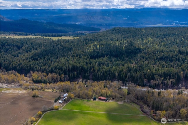 birds eye view of property featuring a mountain view and a forest view