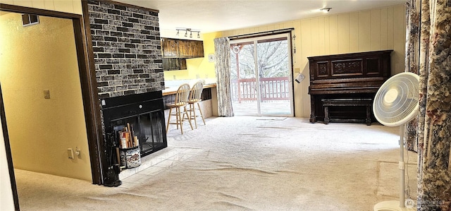 living room featuring visible vents, a fireplace, and carpet