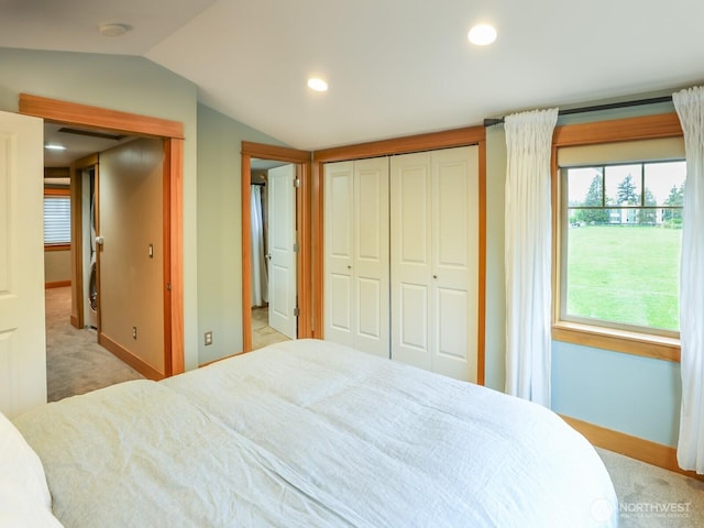 bedroom featuring baseboards, carpet, and vaulted ceiling