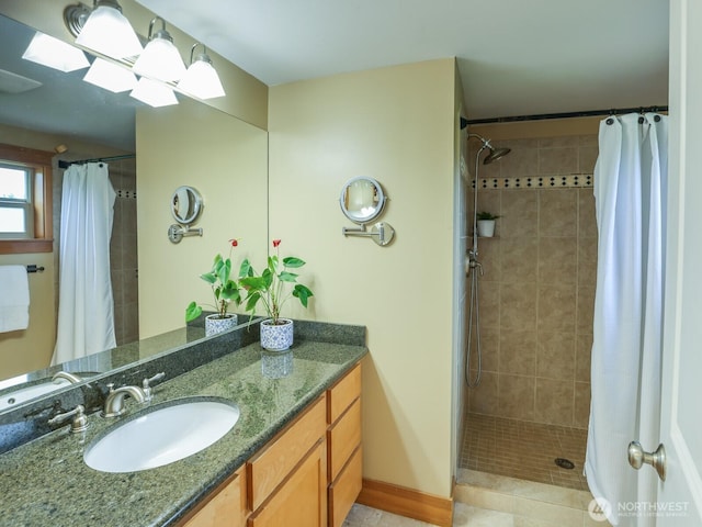 bathroom with vanity and a tile shower