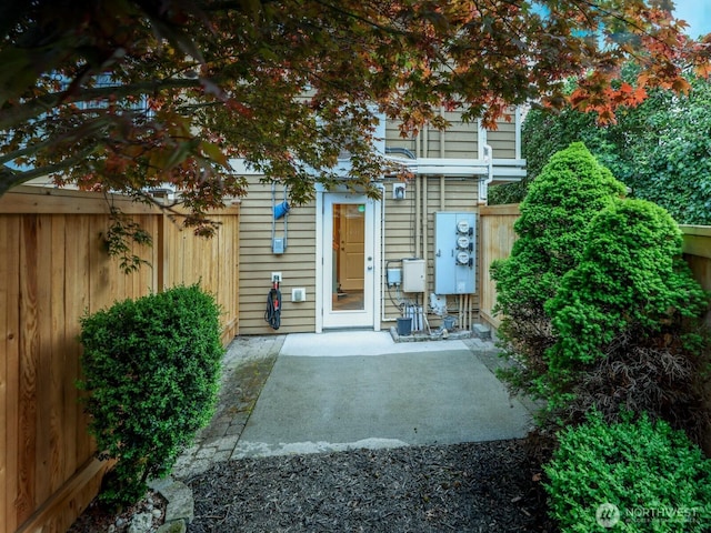 rear view of house with a patio and fence