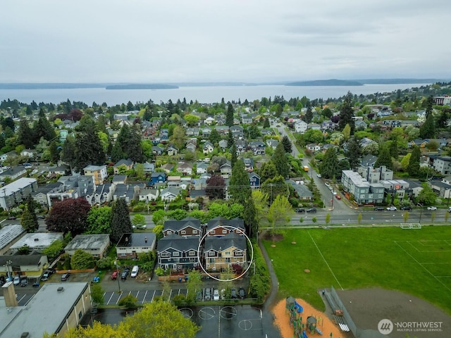 drone / aerial view featuring a residential view and a water view