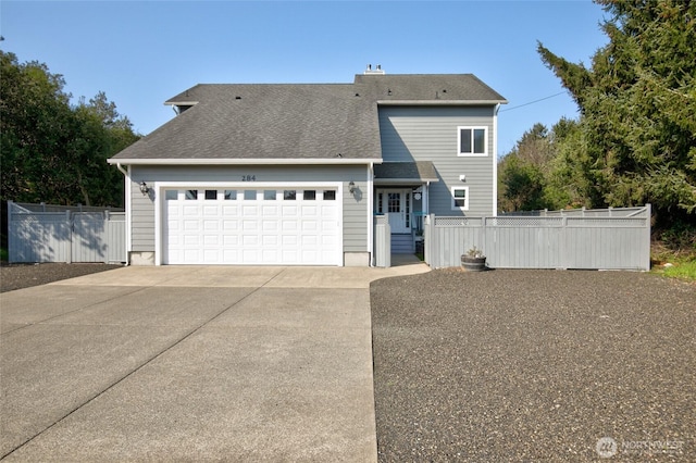 view of front facade with a garage, fence, driveway, and roof with shingles