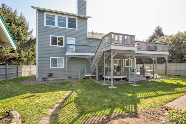 back of house with a deck, stairs, a chimney, and a fenced backyard