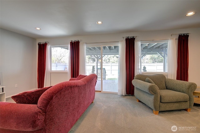 living room featuring recessed lighting, light carpet, and a healthy amount of sunlight