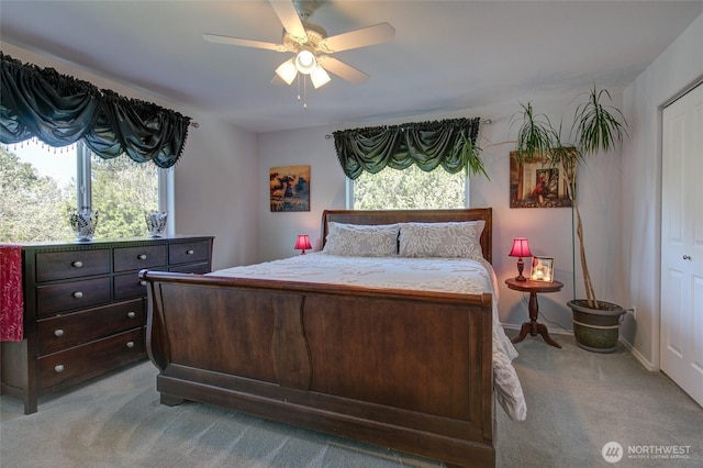 bedroom featuring a ceiling fan and light carpet