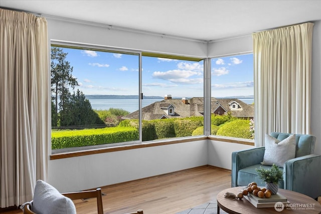 sunroom / solarium featuring a water view