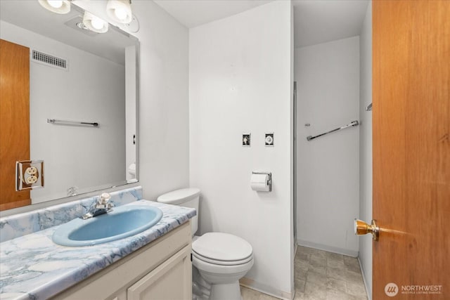 bathroom with visible vents, baseboards, toilet, and vanity