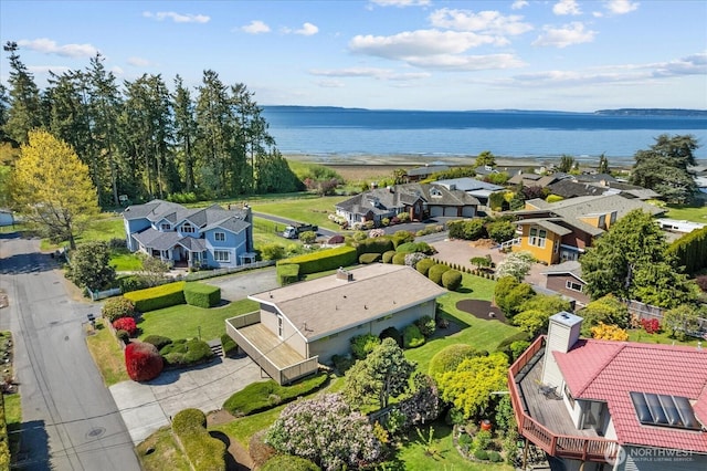 drone / aerial view with a water view and a residential view