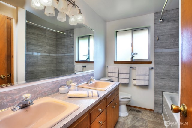 full bath featuring toilet, visible vents, a sink, and a shower