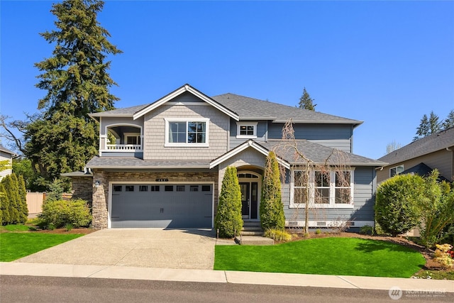 craftsman-style home with a garage, a balcony, driveway, and a front yard