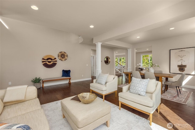 living area with recessed lighting, baseboards, decorative columns, and wood finished floors