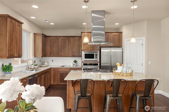 kitchen featuring island range hood, light stone countertops, a sink, stainless steel appliances, and dark wood-type flooring