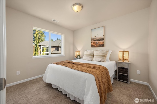 bedroom featuring baseboards, visible vents, and carpet