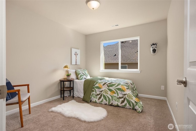 carpeted bedroom featuring baseboards and visible vents