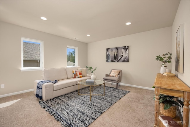 carpeted living area featuring baseboards and recessed lighting