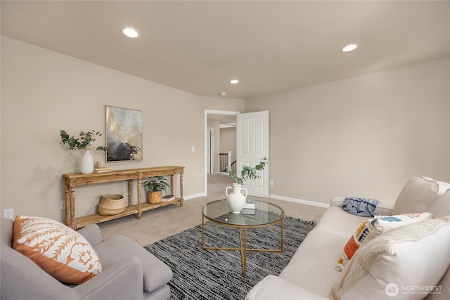 carpeted living area featuring recessed lighting and baseboards