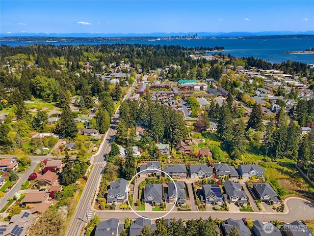 drone / aerial view featuring a water view and a residential view