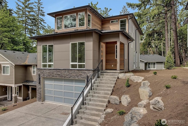 1343 211th Ave NE, Sammamish, WA 98074 - modern home featuring concrete driveway, stone siding, and a garage