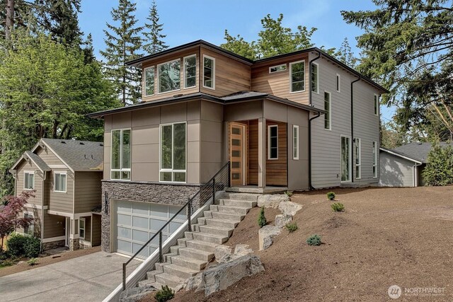 1343 211th Ave NE, Sammamish, WA 98074 - contemporary house featuring driveway, an attached garage, and stone siding