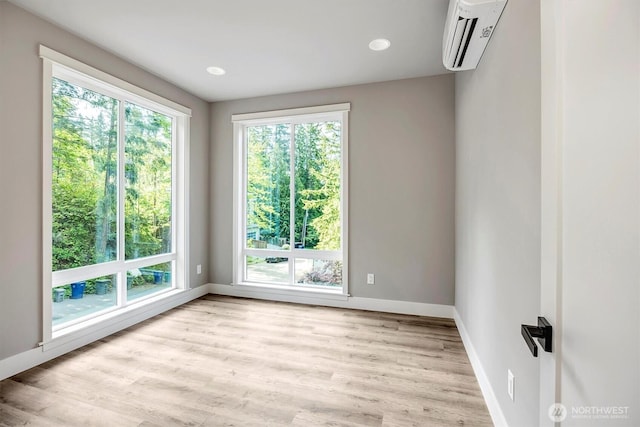 1343 211th Ave NE, Sammamish, WA 98074 - empty room featuring a wall mounted air conditioner, plenty of natural light, and light wood finished floors