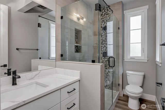 1343 211th Ave NE, Sammamish, WA 98074 - bathroom with vanity, healthy amount of natural light, wood finished floors, and a shower stall