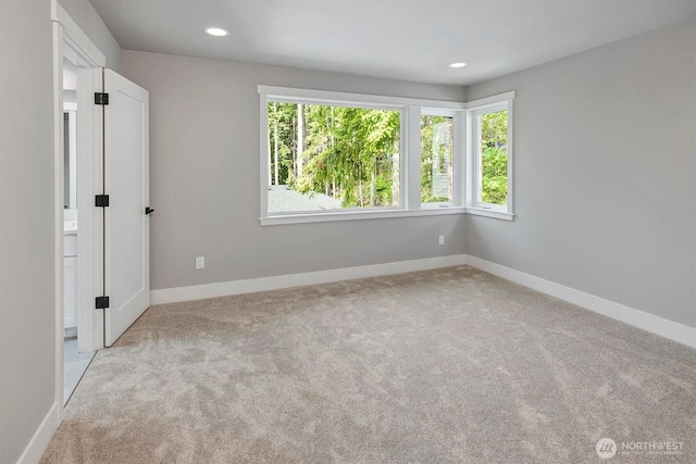 1343 211th Ave NE, Sammamish, WA 98074 - unfurnished bedroom featuring multiple windows, light carpet, and recessed lighting