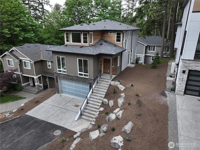 1343 211th Ave NE, Sammamish, WA 98074 - view of front facade with driveway, a shingled roof, a garage, stairway, and stone siding