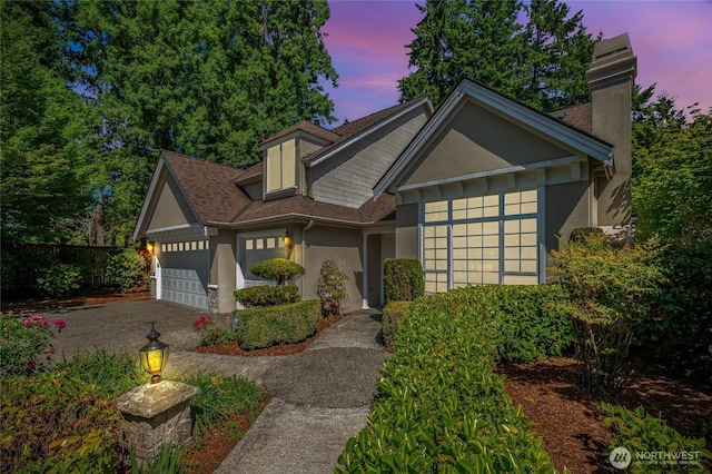 16639 Northup Way, Bellevue, WA 98008 - view of front of home with stucco siding, an attached garage, driveway, a chimney, and a shingled roof