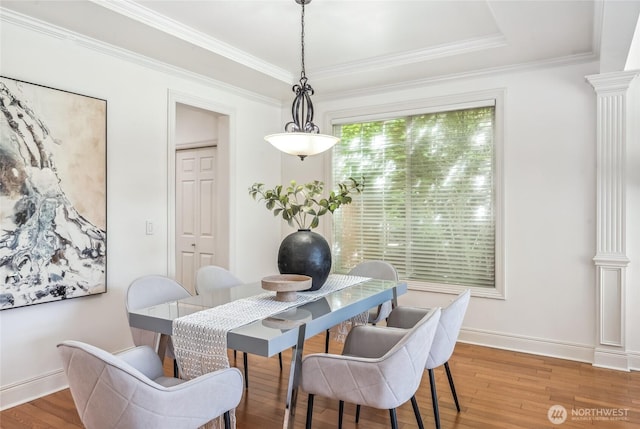 16639 Northup Way, Bellevue, WA 98008 - dining space with light wood-style flooring, crown molding, and decorative columns