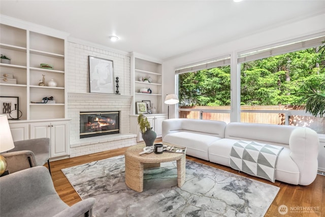 16639 Northup Way, Bellevue, WA 98008 - living room featuring a fireplace, wood finished floors, and built in features