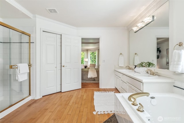 16639 Northup Way, Bellevue, WA 98008 - full bath with wood-type flooring, double vanity, a bath, a shower stall, and ornamental molding