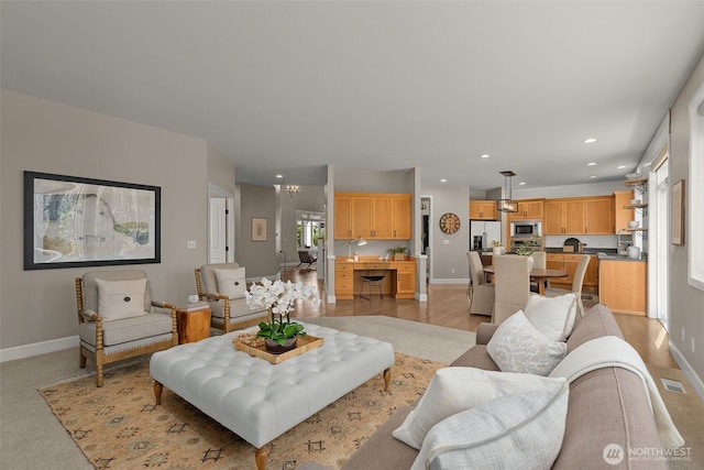 living area featuring baseboards, recessed lighting, and visible vents