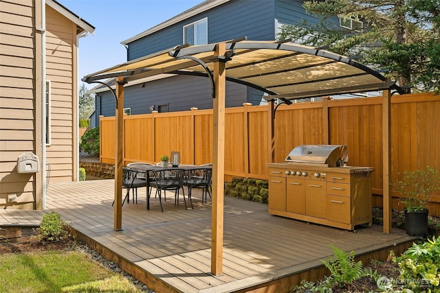 wooden terrace featuring fence, a pergola, and outdoor dining space